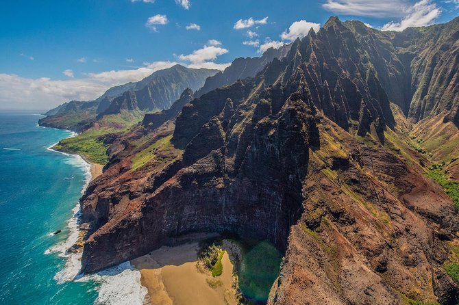 A helicopter banking over the green sea cliffs of Kauai