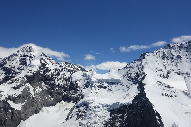 Private Swiss Alps helicopter tour over snow covered mountain peaks and glaciers - Seeing the Swiss Alps from a private helicopter